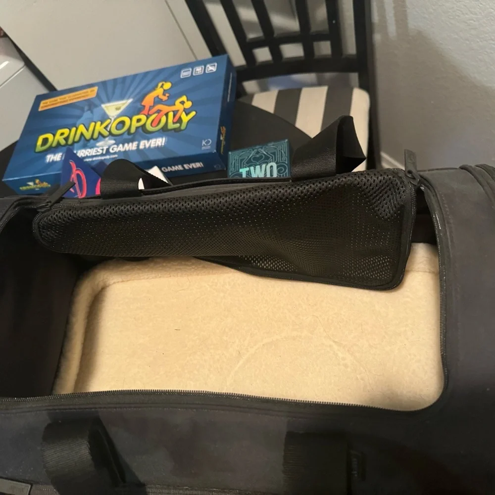 Small dog carrier. a little bed inside. Never used. Two openings. 2 sidezippers
